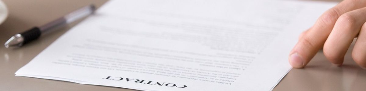 Close up photo of mortgage contract and keys on the table. Couple decided to take out mortgage for buying own apartment, family found reliable building company and purchasing new house